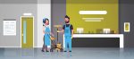 couple janitors man woman in uniform working together cleaning service concept cleaners pushing trolley cart with tools modern hospital reception interior full length flat horizontal